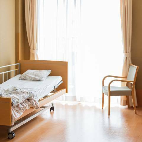 Chambre individuelle en EHPAD Chambre simple en EHPAD avec un lit médicalisé, un fauteuil, une armoire et une télévision.